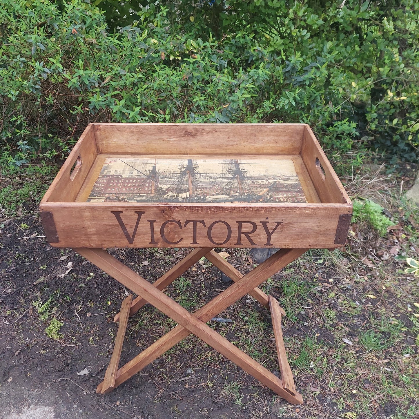 Solid wood butler tray on a fold away stand HMS Victory print